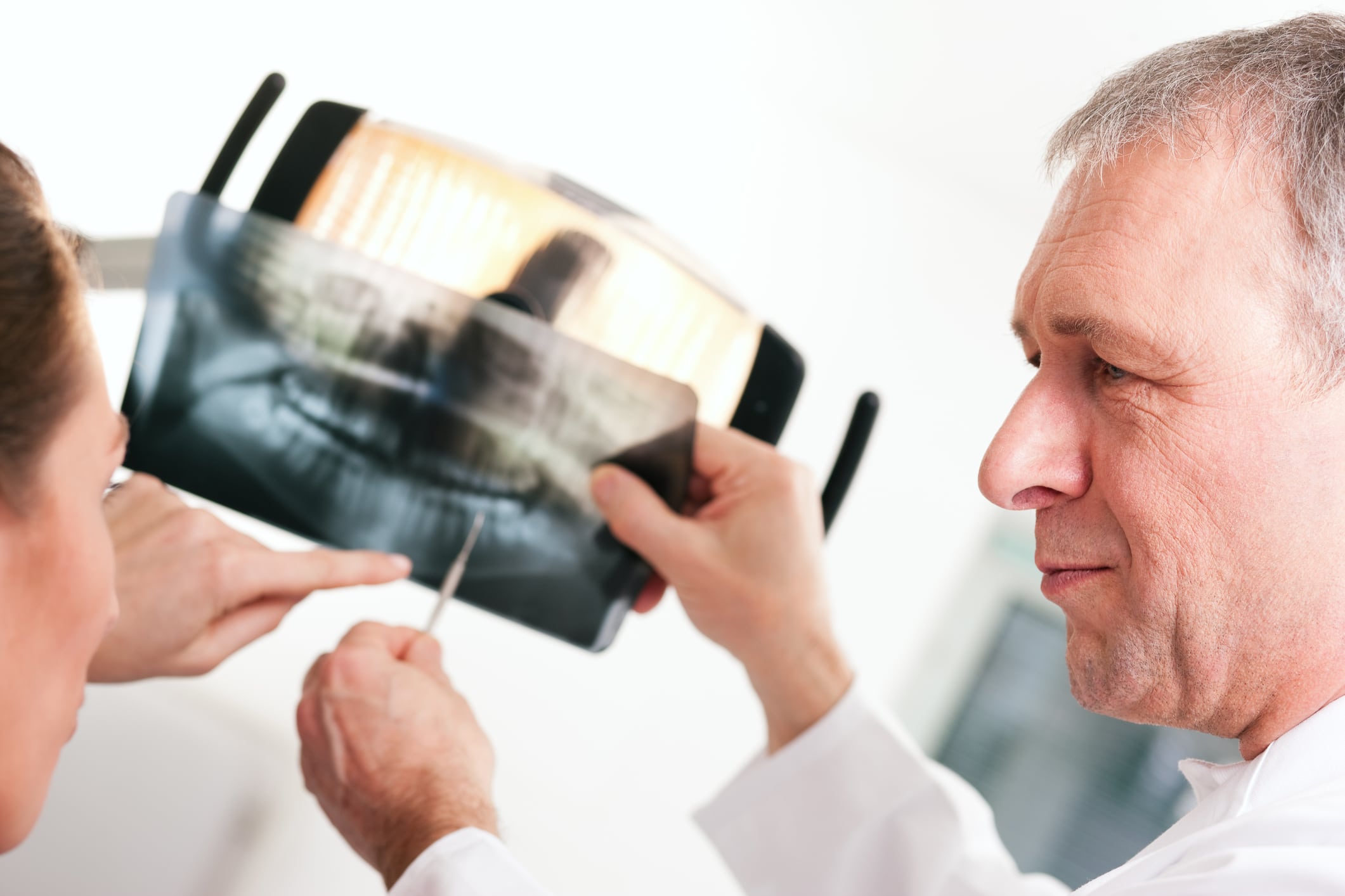dentist-explaining-x-ray-to-patient-15160242 dentist explaining x-ray to patient about biological dentistry